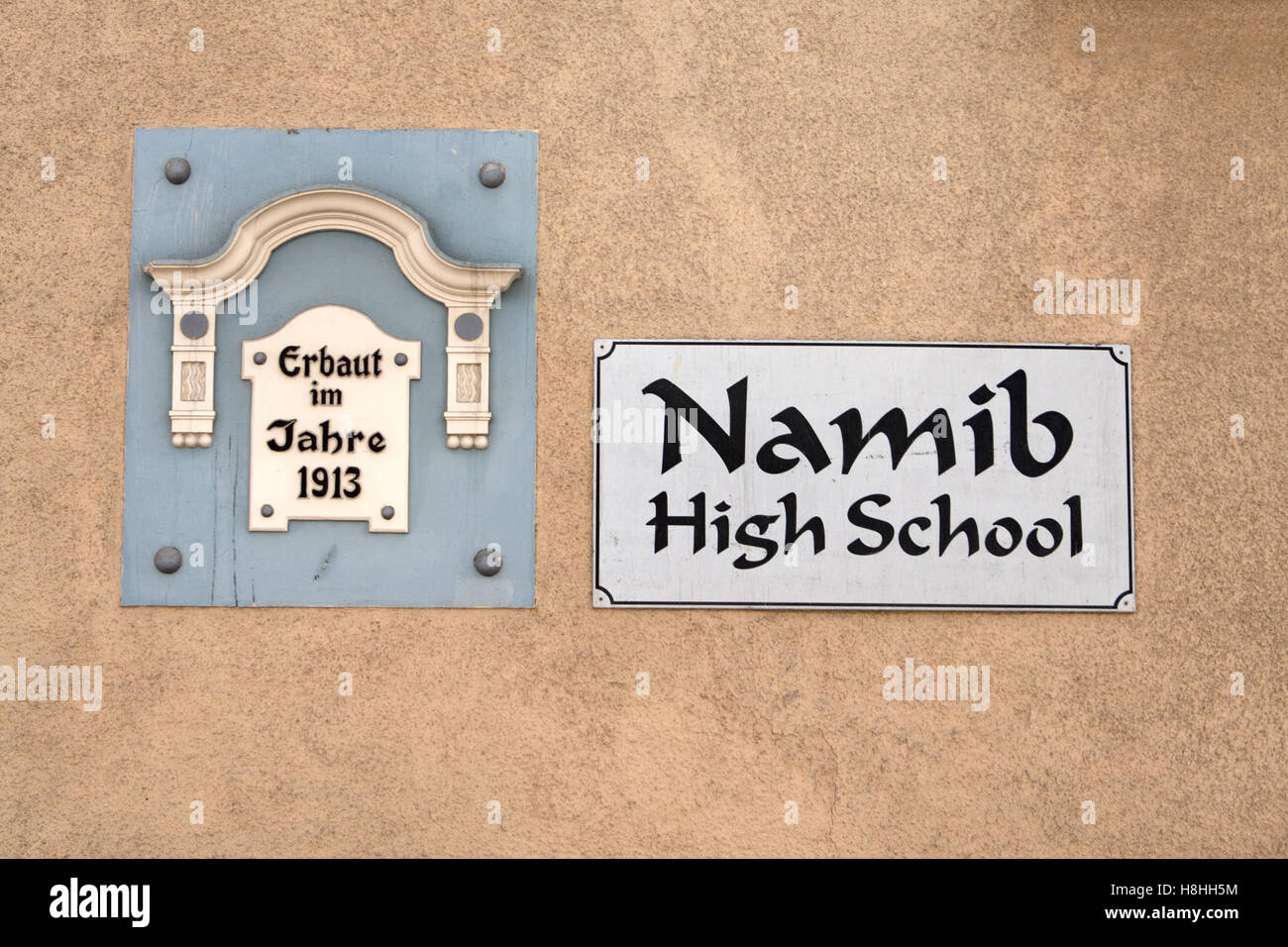 Two signs on the outer wall of the Namib High School in Swakopmund, Namibia Stock Photo