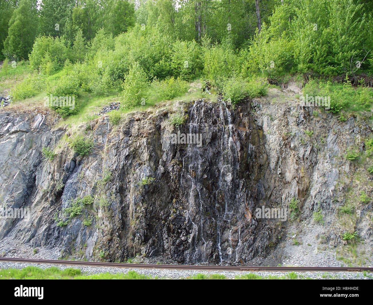Water Flowing Off A Rocky Cliff In The Chugach National Forrest Near Whittier, Alaska Stock Photo