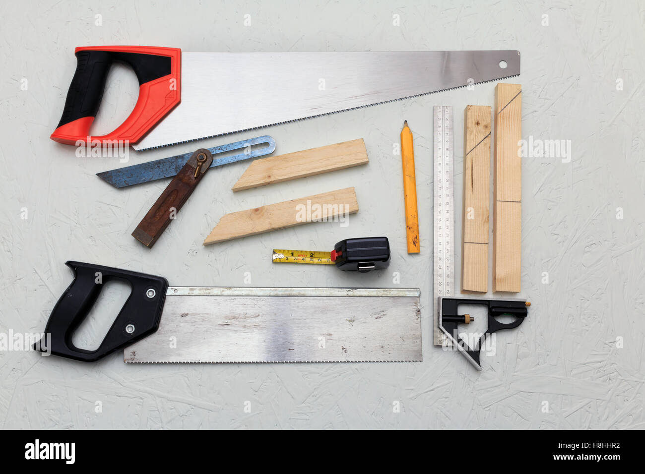 Small Collection of wood working tools made up of, hand saws, squares, tape measure and pencil Stock Photo
