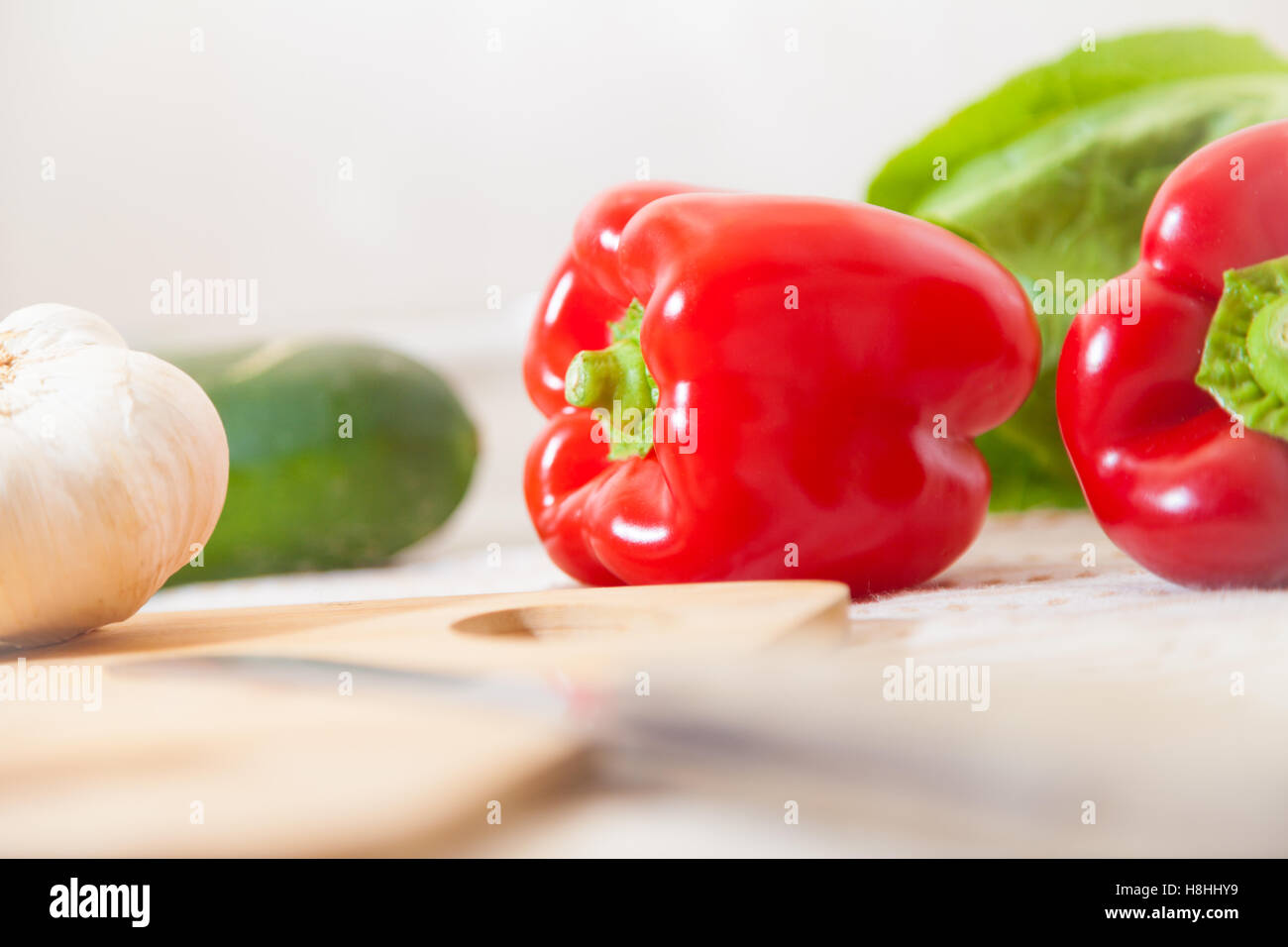 red paprika lies with other vegetables on a table Stock Photo