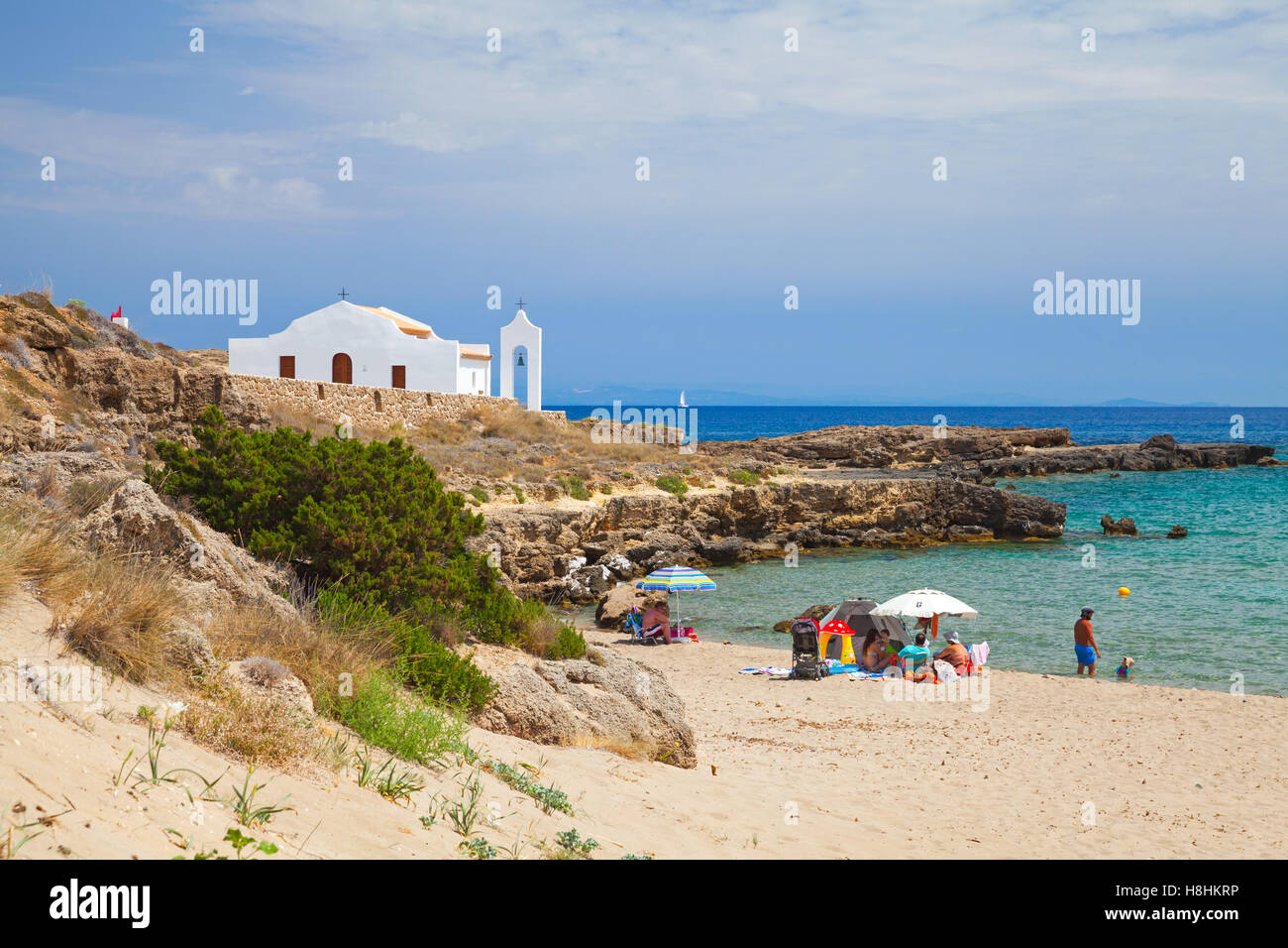 Zakynthos, Greece - August 18, 2016: Coastal landscape of Agios Nikolaos beach. White Orthodox church on the Ionic Sea coast Stock Photo
