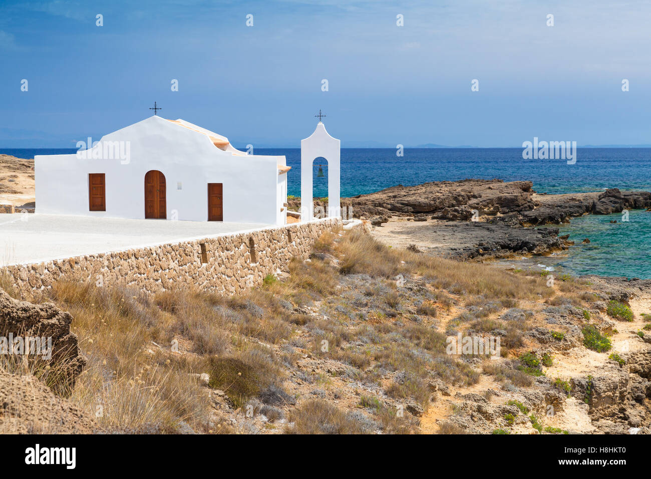 Coastal landscape of Agios Nikolaos. White Orthodox church on the Ionic Sea coast. Zakynthos island, Greece Stock Photo