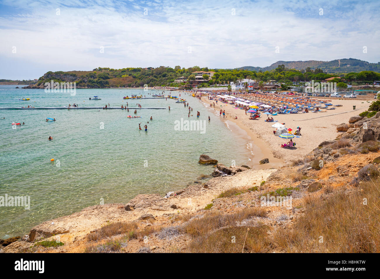 Tourists relax on Agios Nikolaos beach, Greek island of zante. It is a popular beach in Vassilikos, Zakynthos, Greece Stock Photo
