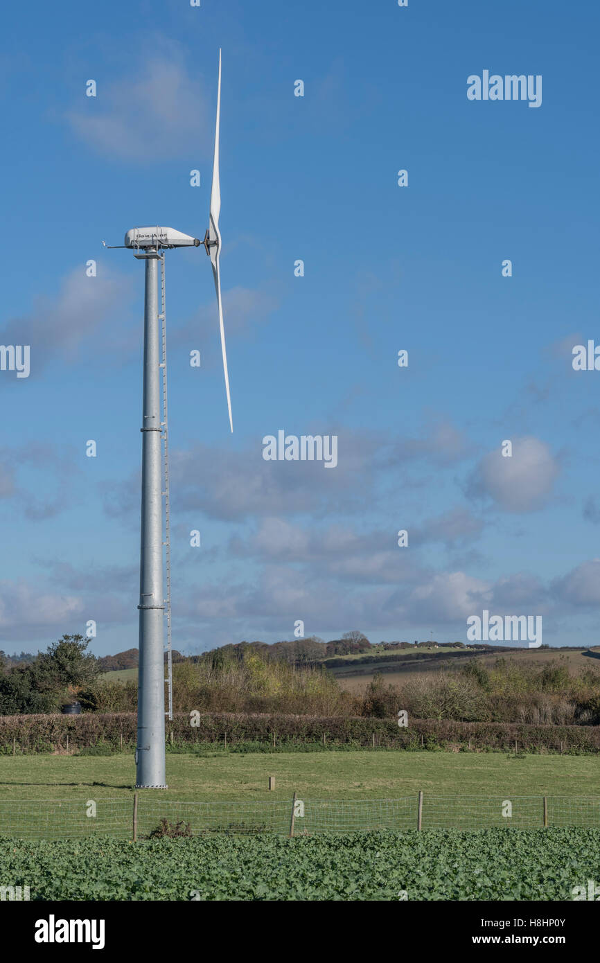 Small-ish, field-based, wind turbine / wind generator set in autumnal sunshine. UK landscape with wind turbine. Stock Photo