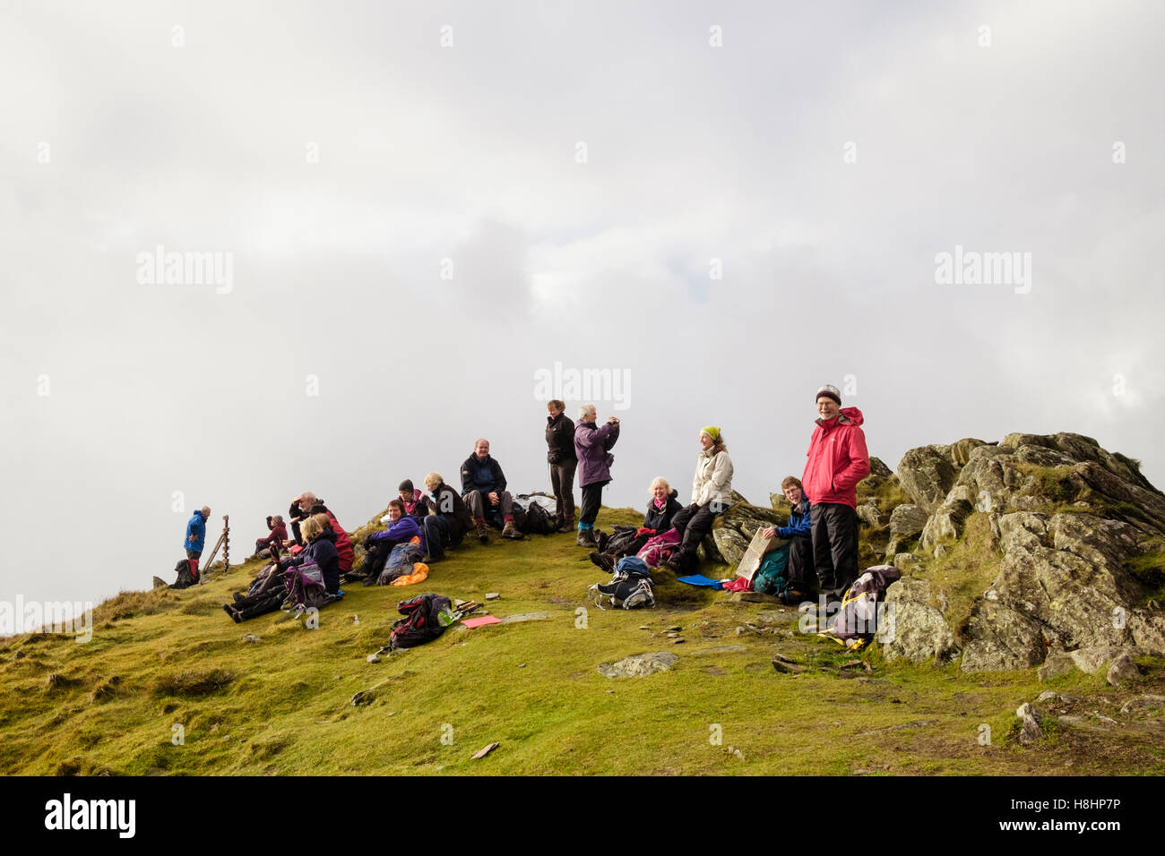 Group of hikers resting on Yr Aran summit in Snowdonia National Park. Gwynedd, Wales, UK, Britain Stock Photo