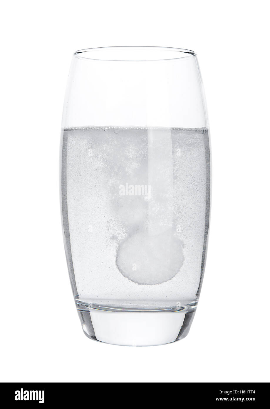 Pill dissolving in glass of water on white background isolated Stock