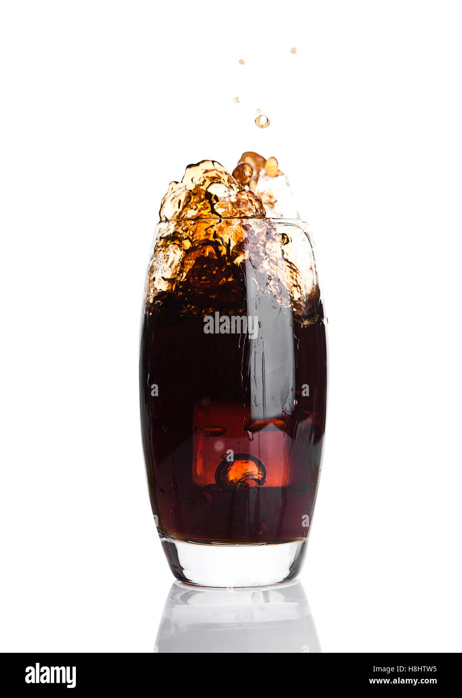 Glass of cola with splash and ice cubes on white background Stock Photo ...