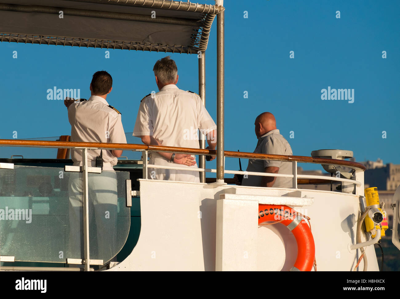 The Captain and crew members on the bridge of a cruise ship Stock Photo
