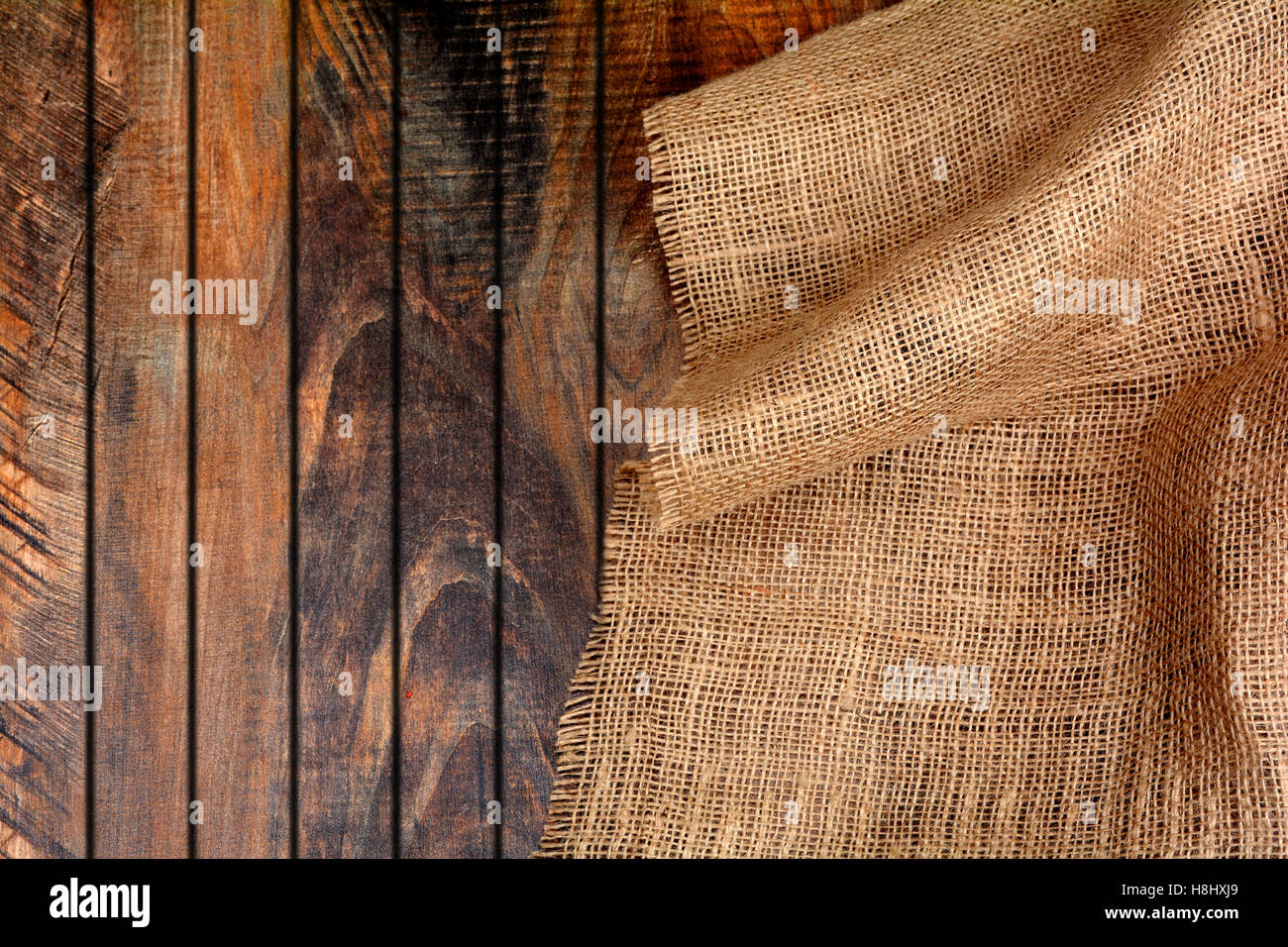 Jute Burlap on Wooden Background Banner Template. Stock Photo