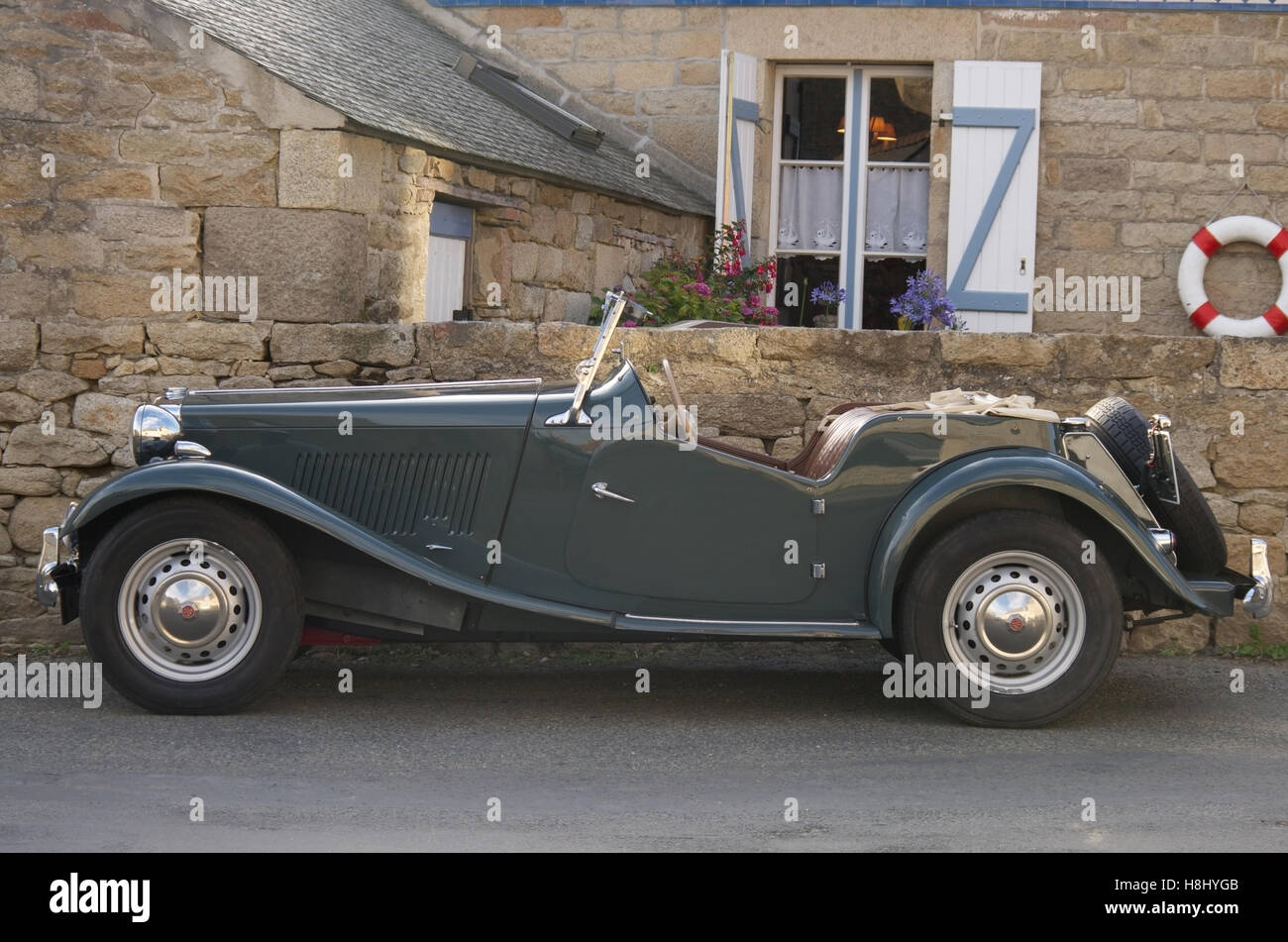 Classic MG TD midget parked outside a French holiday home, Brittany Stock Photo