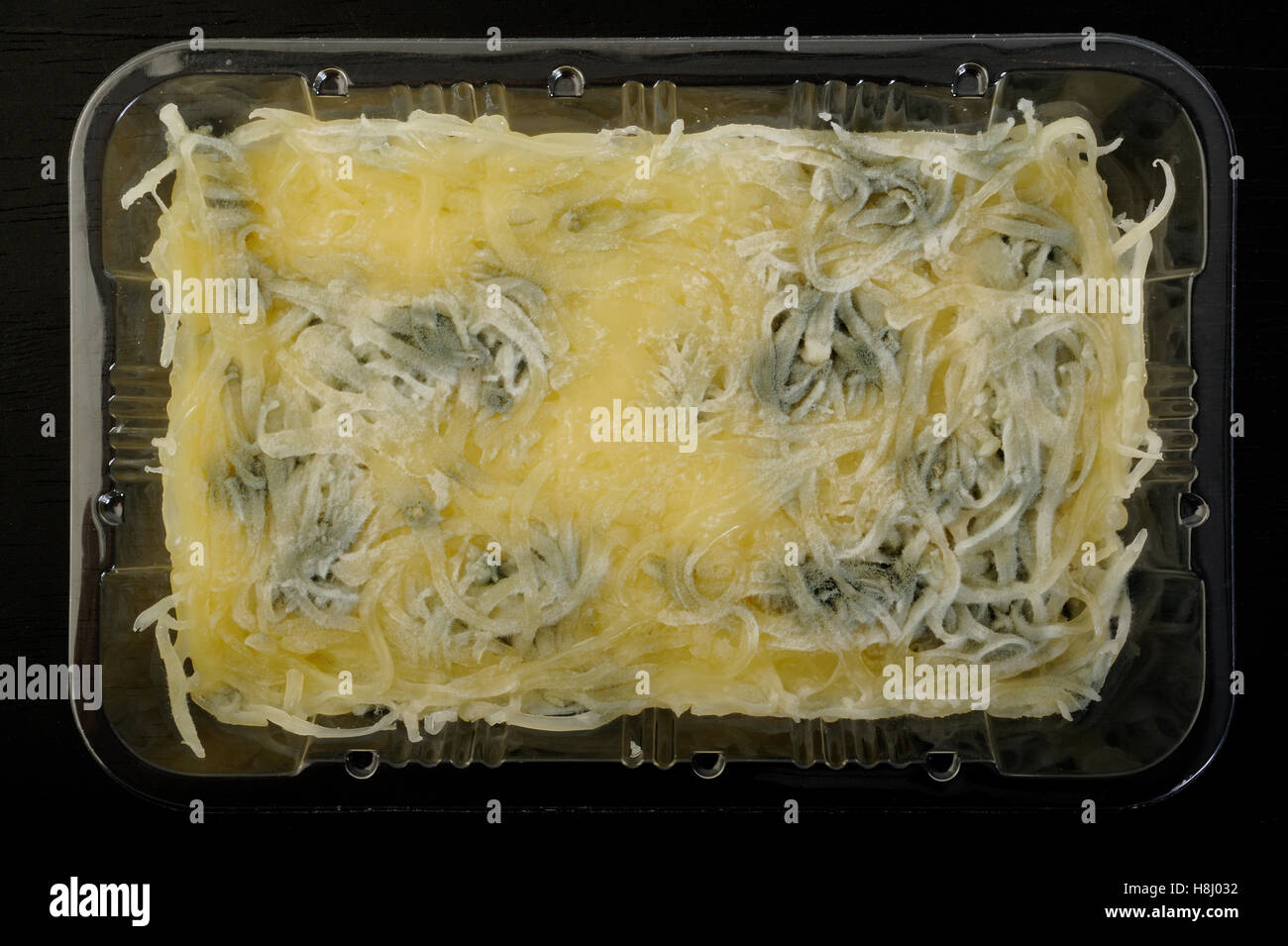 Grated cheddar cheese in plastic container Stock Photo - Alamy