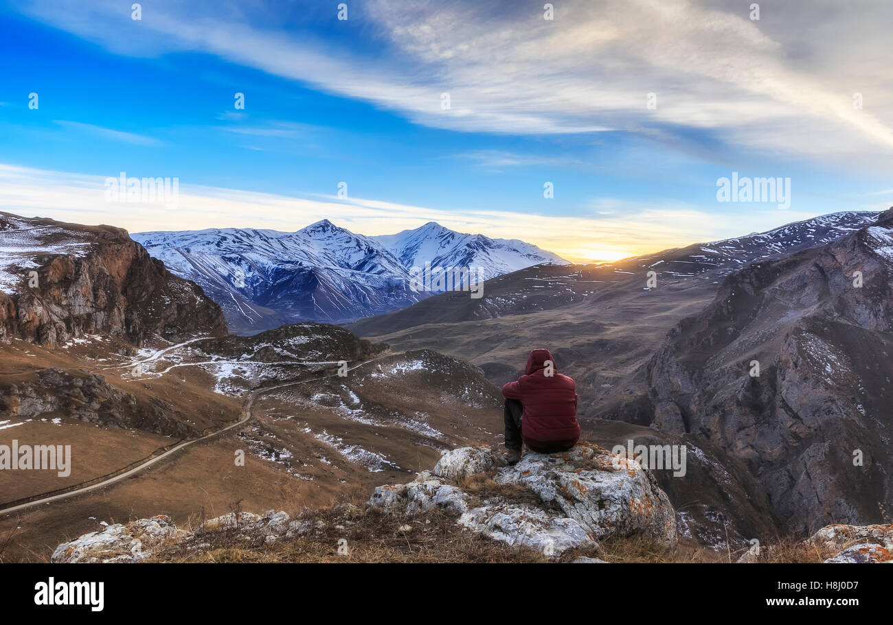 Young guy overlooks the mountainous surroundings of the village Xınalıq.Azerbaijan Stock Photo
