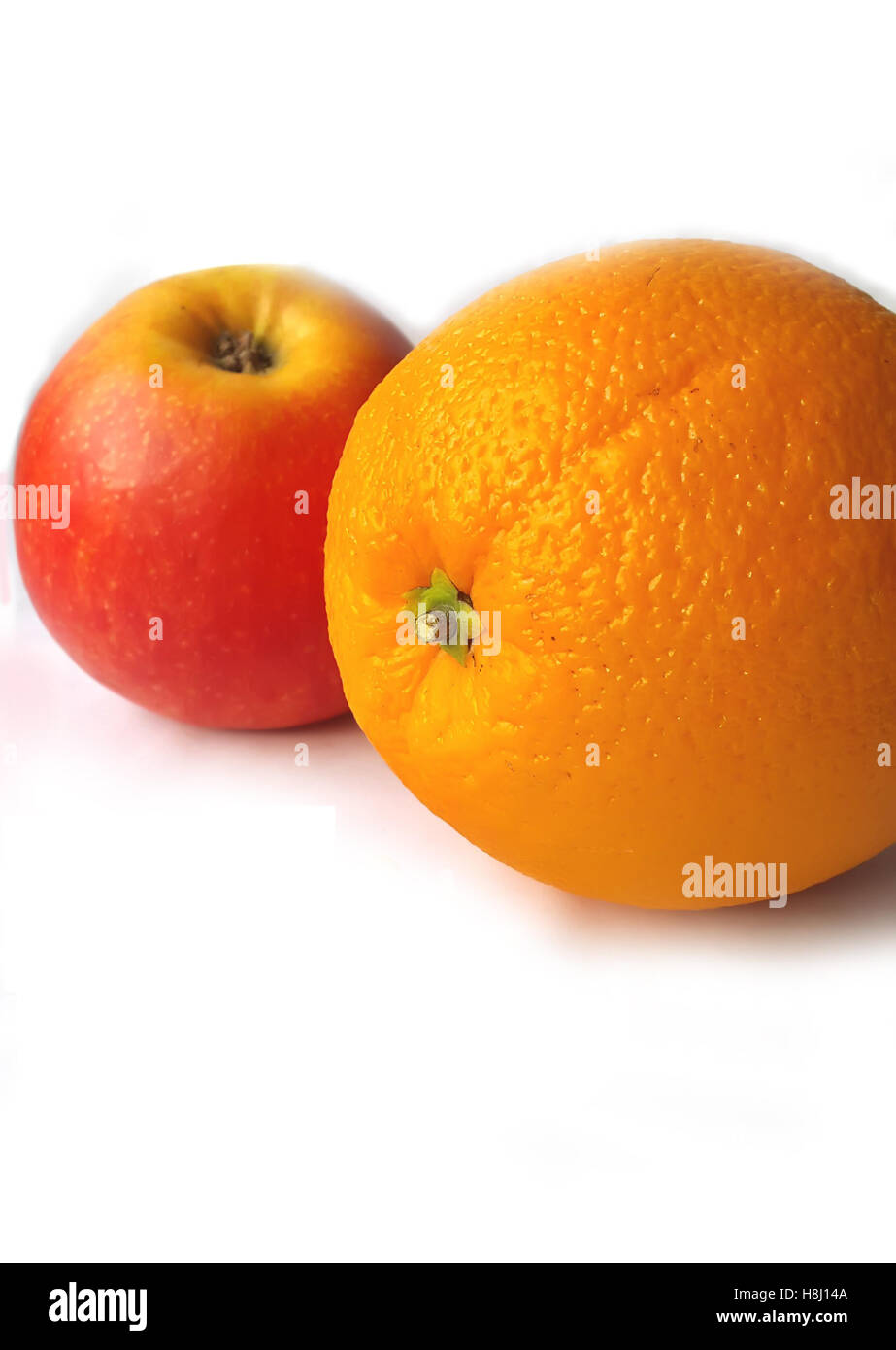 Orange and apple on a white background. Stock Photo