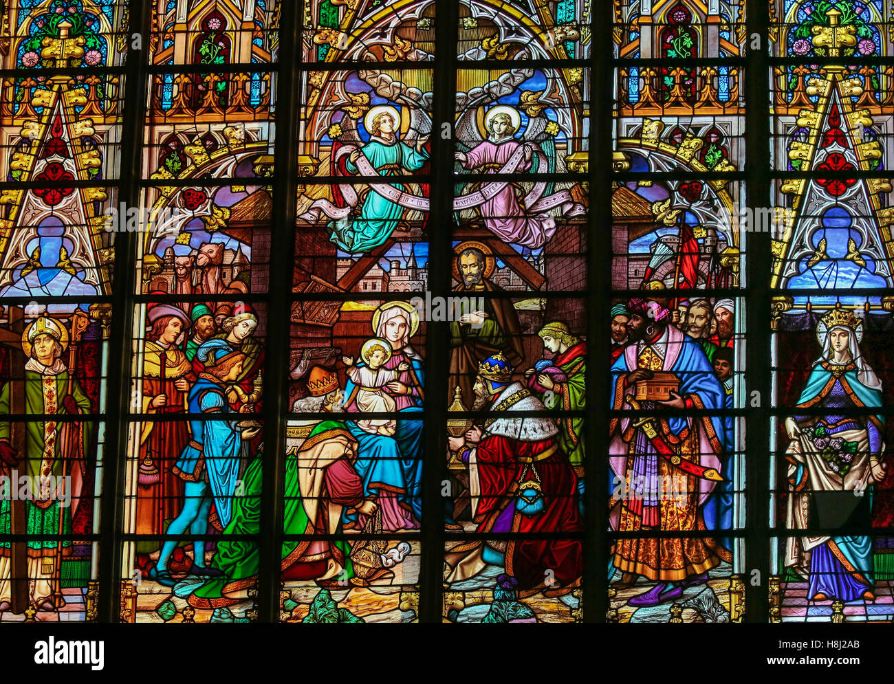 Stained Glass window depicting the Epiphany, the Visit of the Three Kings in Bethlehem, in the Cathedral of St Rumbold of Mechel Stock Photo