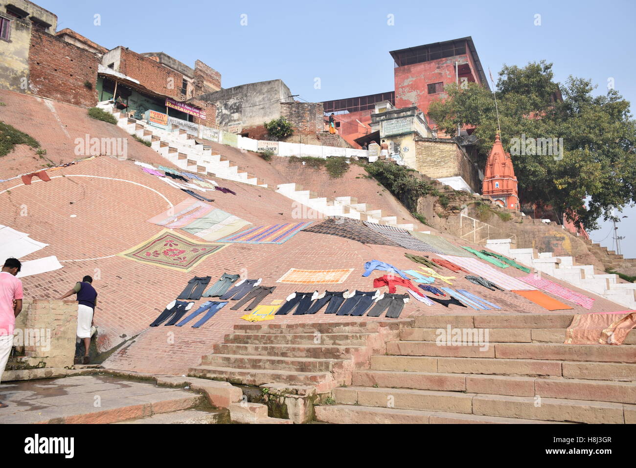Pants and other clothes drying at the sun on the ghats in Varanasi, Uttar Pradesh, India Stock Photo
