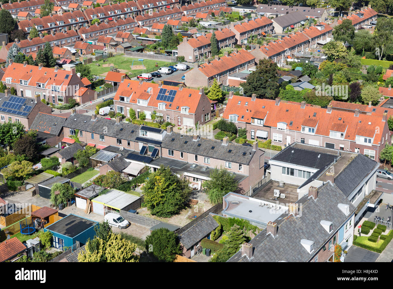 Aerial view family houses with backyards in residential area of Dutch
