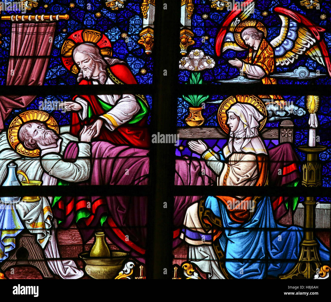 Stained Glass window depicting the Death of Saint Joseph, with Mother Mary and Jesus, in the Cathedral of Saint Rumboldt in Mech Stock Photo
