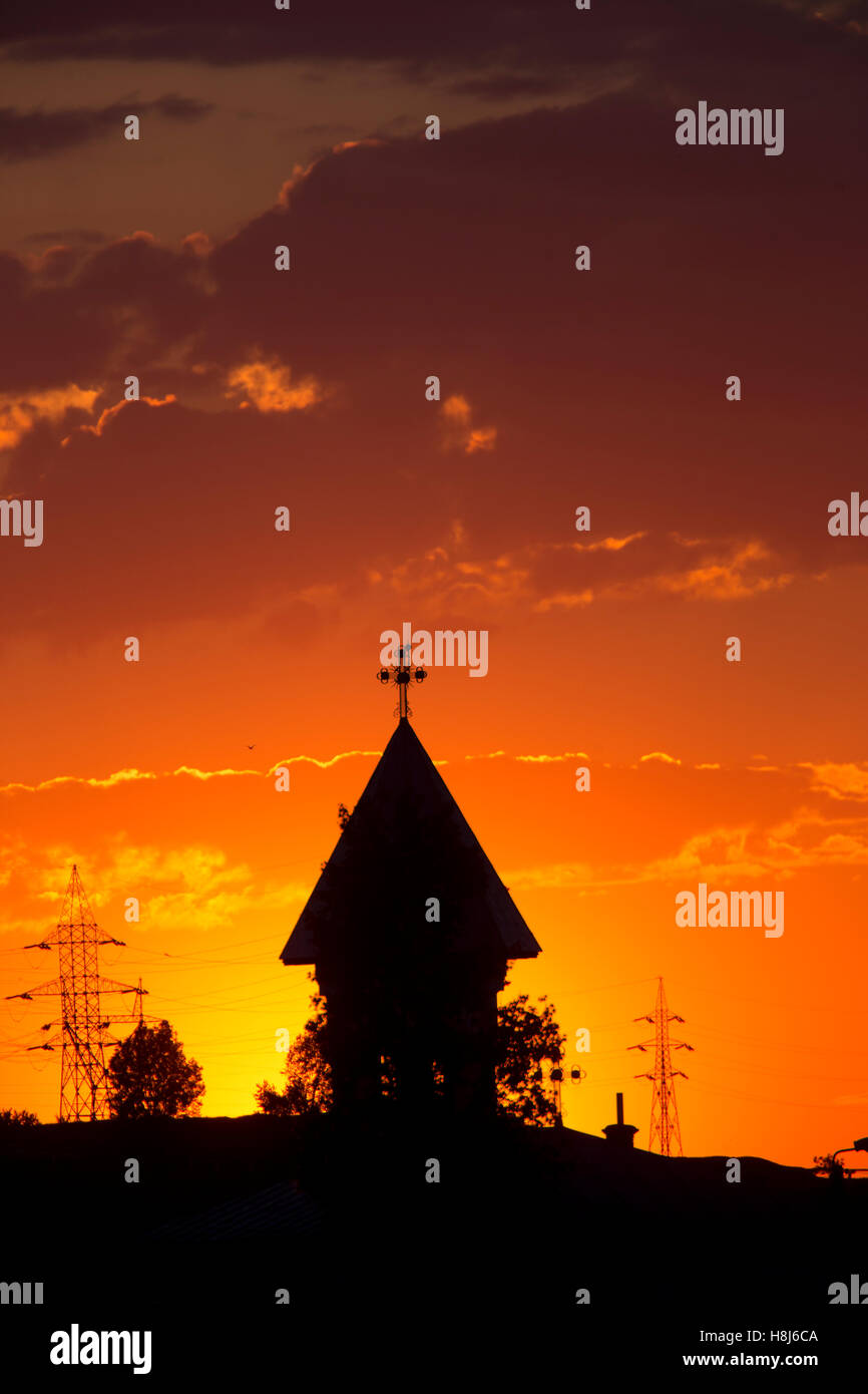 Sunset over the town with church tower, Tulcea, Romania. Stock Photo