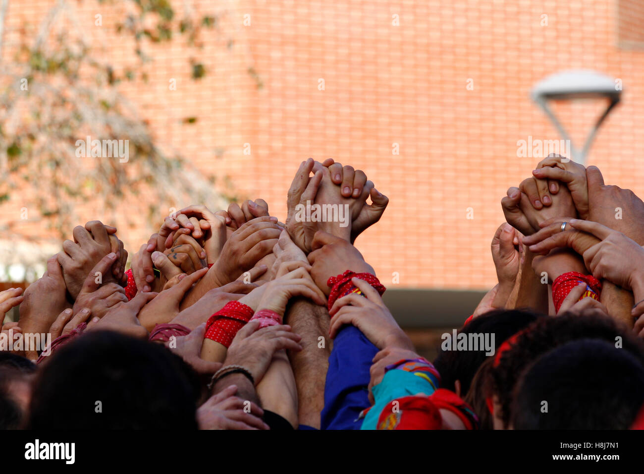 Group of people with hands up together, Catellers teamwork Stock Photo