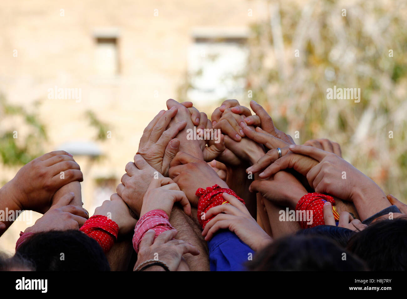 Group of people with hands up together, Catellers teamwork Stock Photo