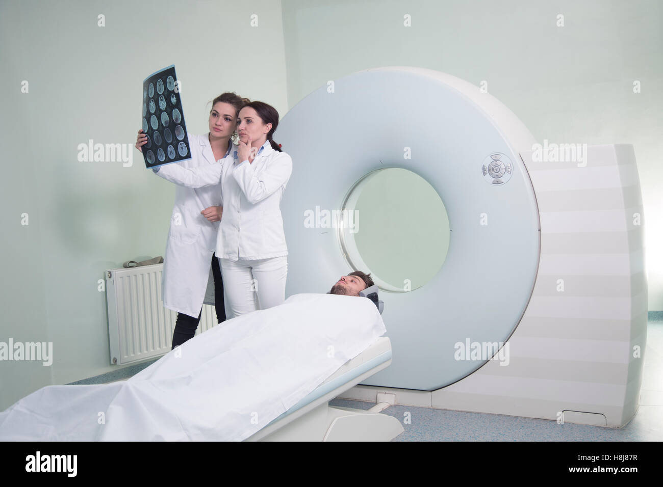 Radiologic technician and Patient being scanned and diagnosed on ...