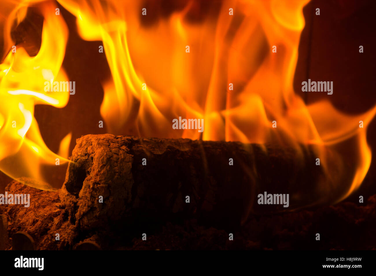 Burning wooden log flame on fire in fireplace Stock Photo Alamy