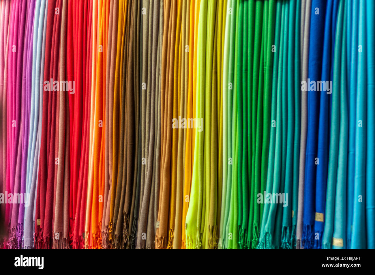 Many scarves in a full spectrum rainbow colors Stock Photo