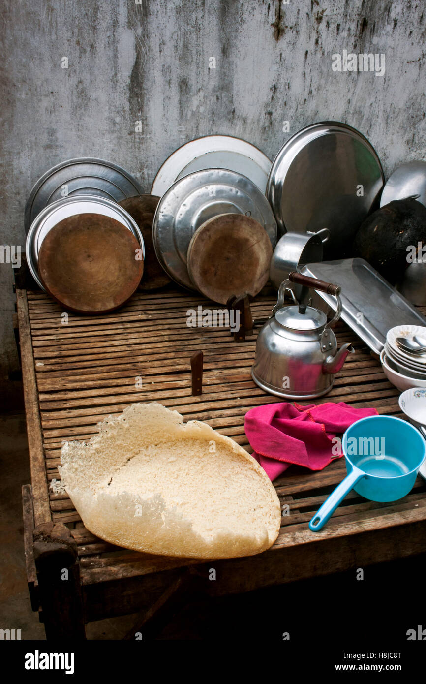 Pots and pans rest on a table in a kitchen at a restaurant in Chork Village, Cambodia. Stock Photo