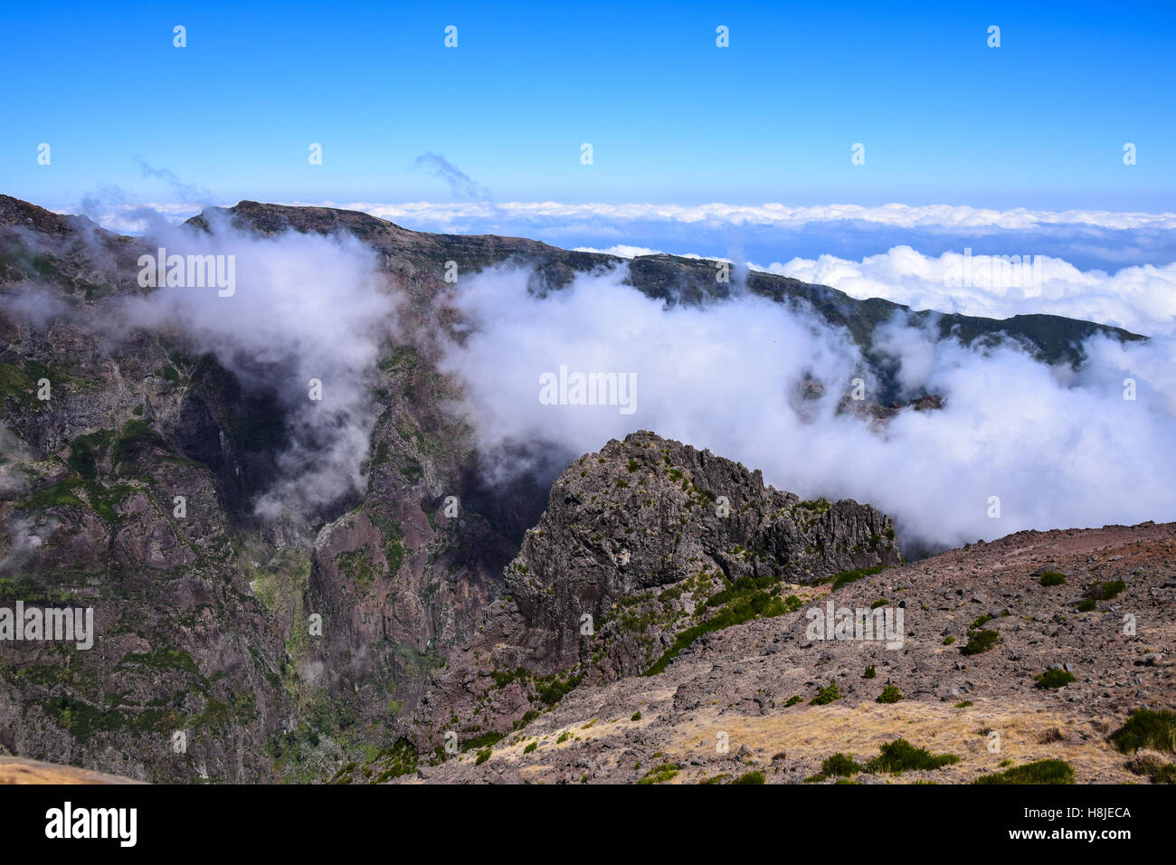 Clouds rolling over mountains Stock Photo - Alamy