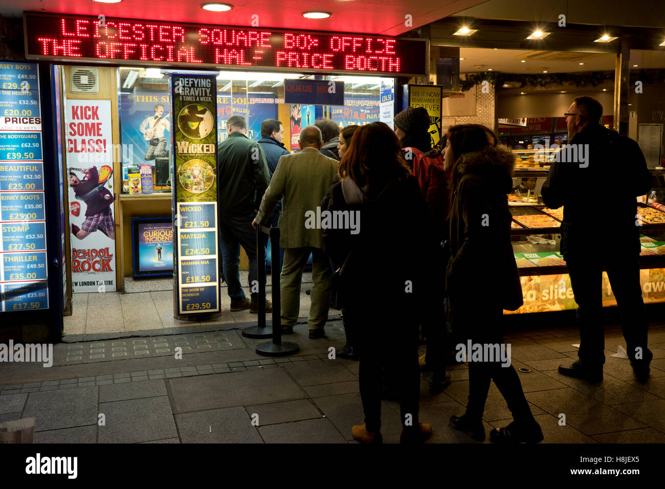 Tourists and visitors in line at a West End show tickets discount store