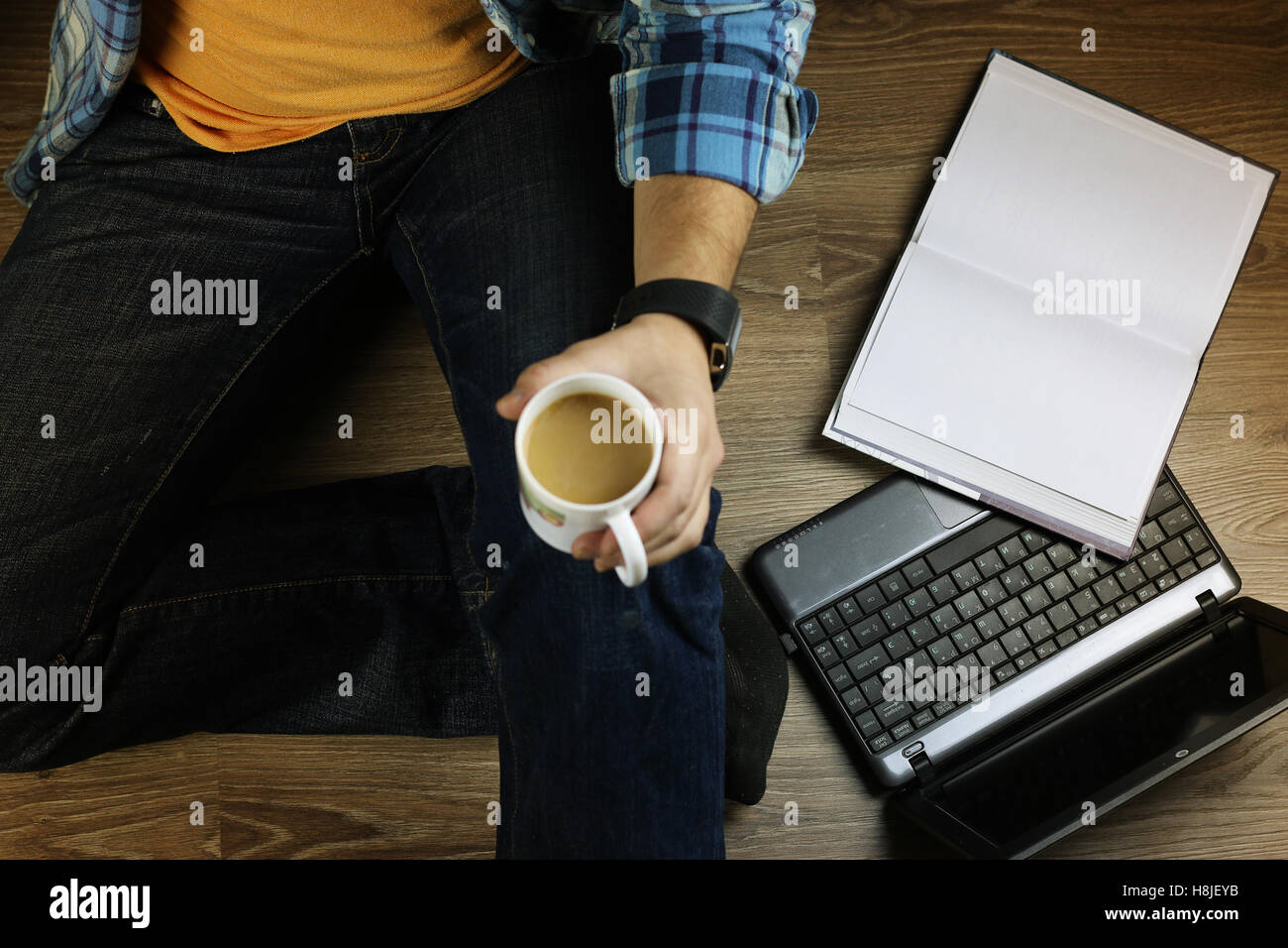 man on the floor with a laptop Stock Photo - Alamy