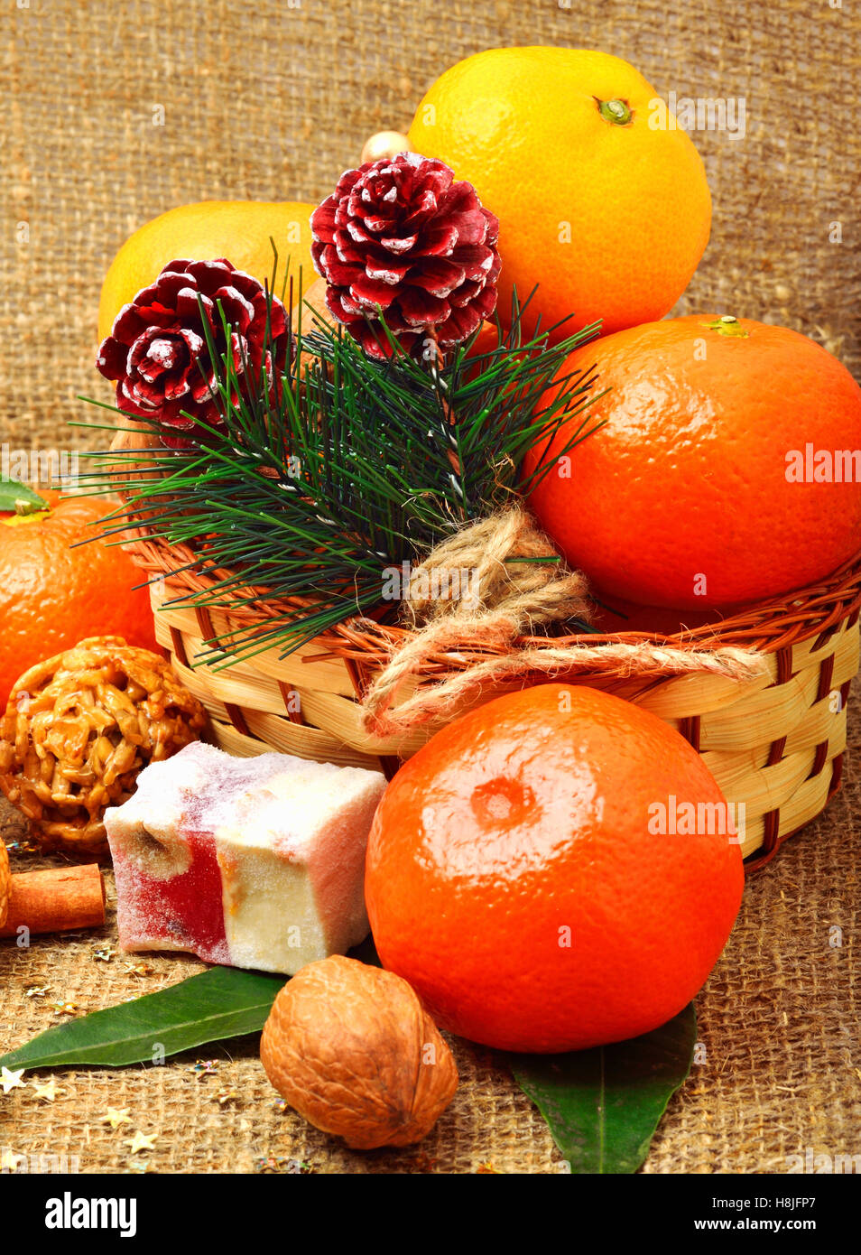 Christmas decoration with mandarines and sweet delights Stock Photo