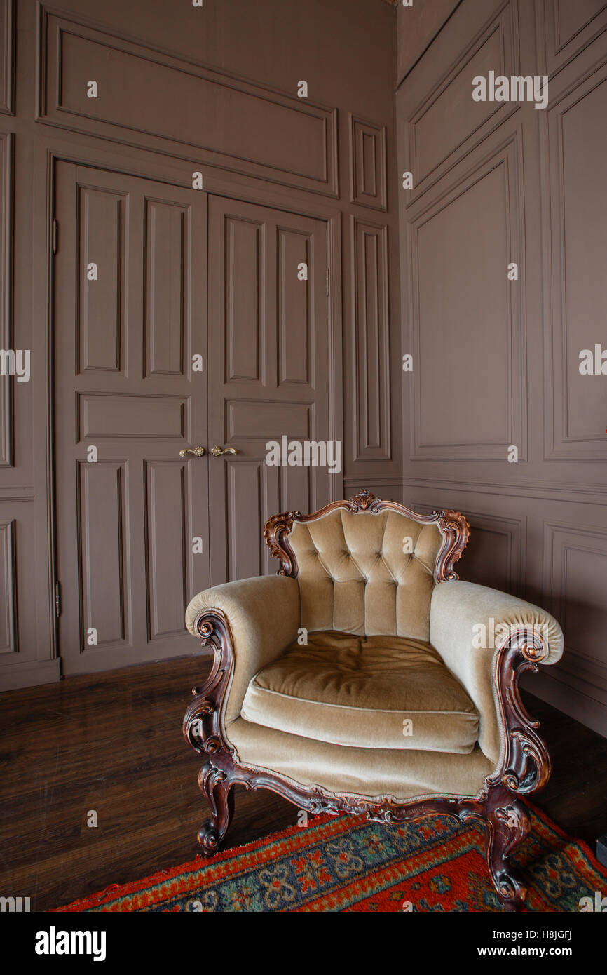 Living room with antique stylish beige armchair Stock Photo Alamy