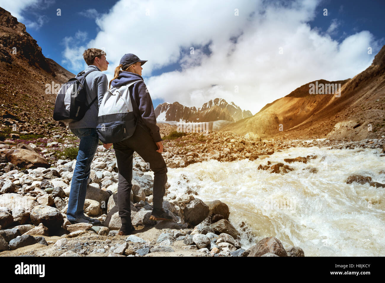 Couple hikers mountains river hiking Stock Photo