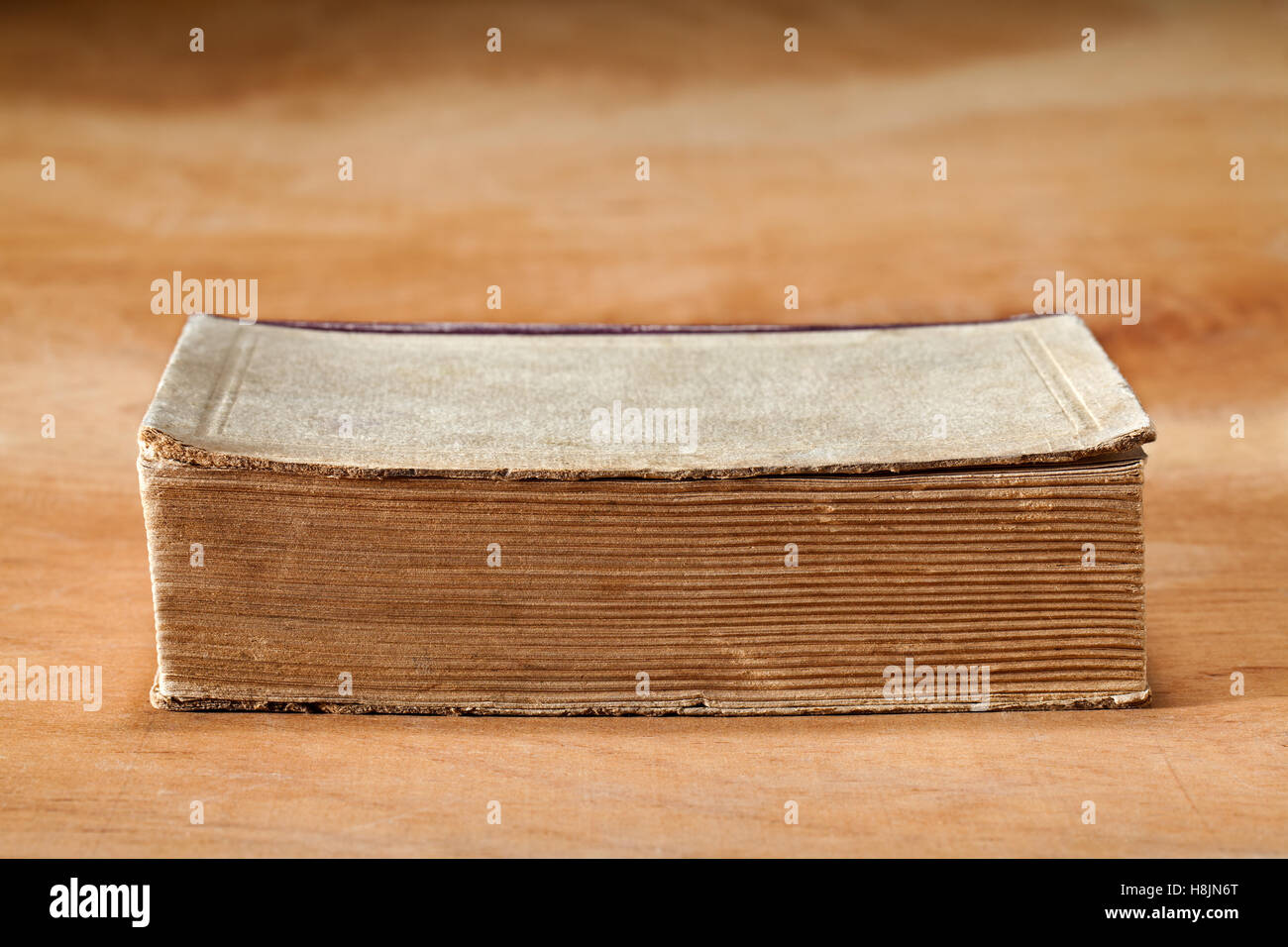 Old book on a wooden table. Stock Photo