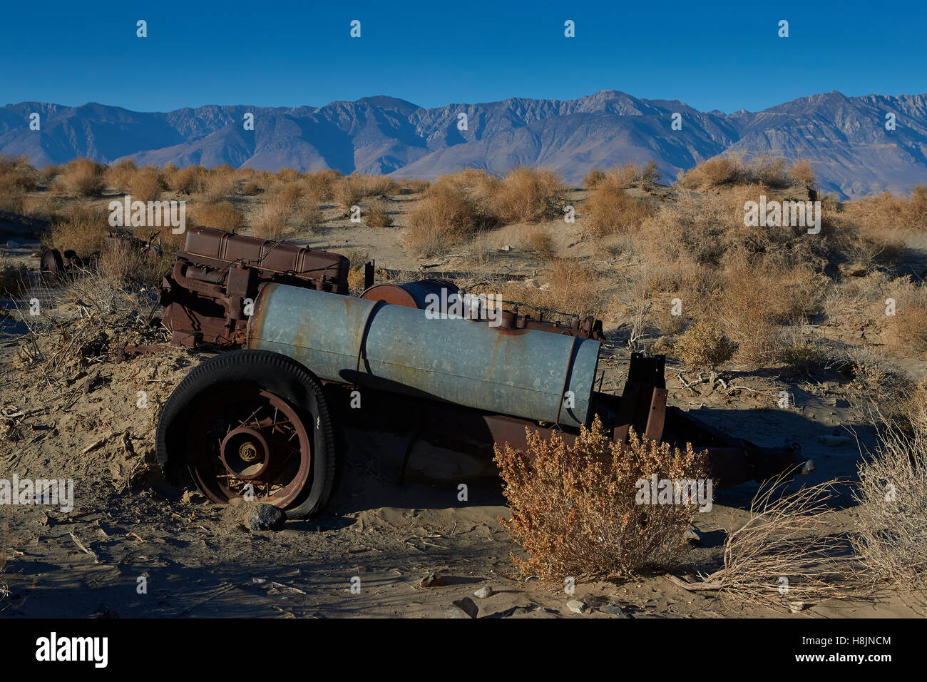 Abandoned Mining Equipment In The Owens Valley With The Sierra Nevada Mountain Range Behind. Stock Photo