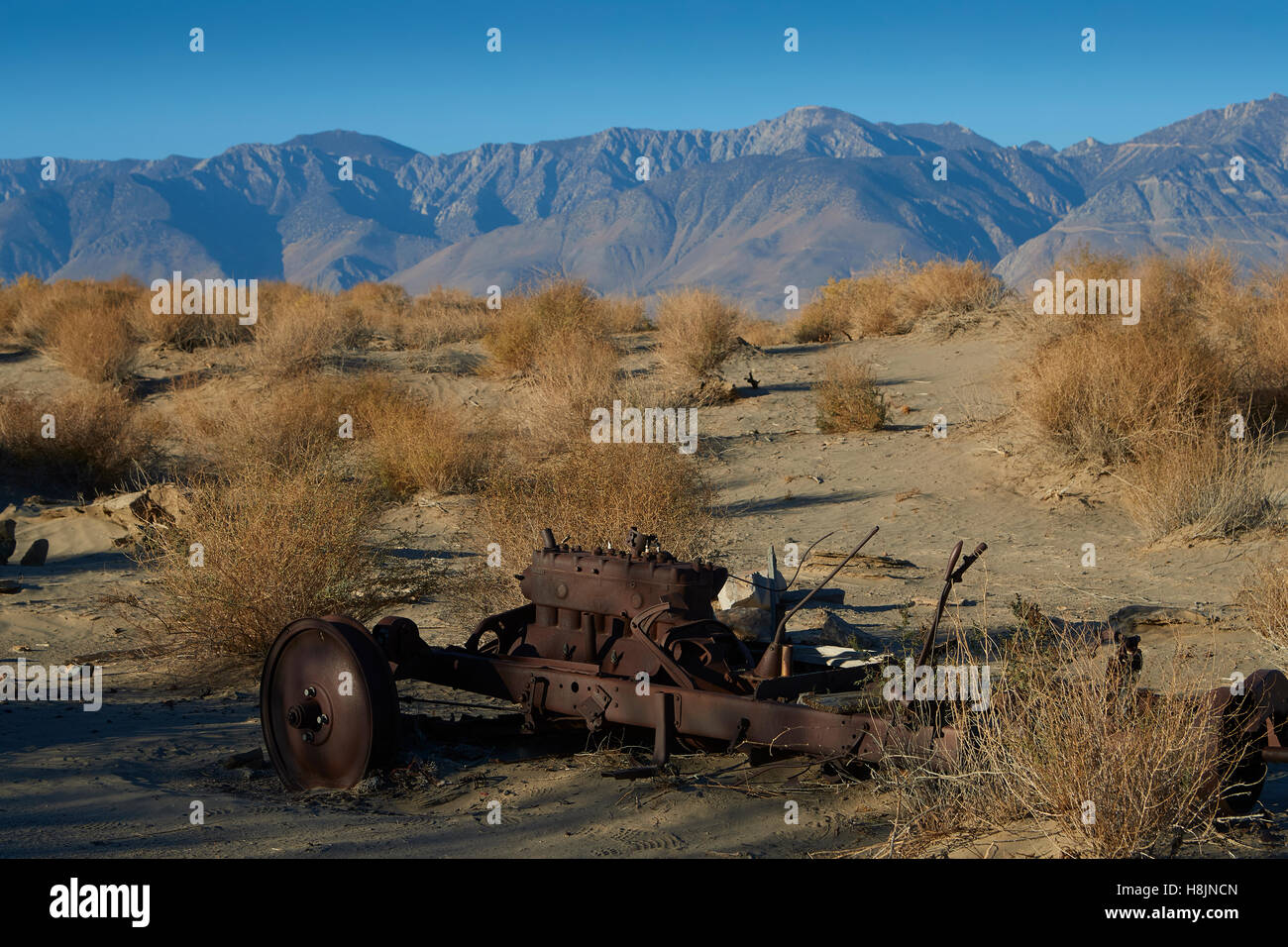 Abandoned Mining Equipment In The Owens Valley With The Sierra Nevada Mountain Range Behind. Stock Photo