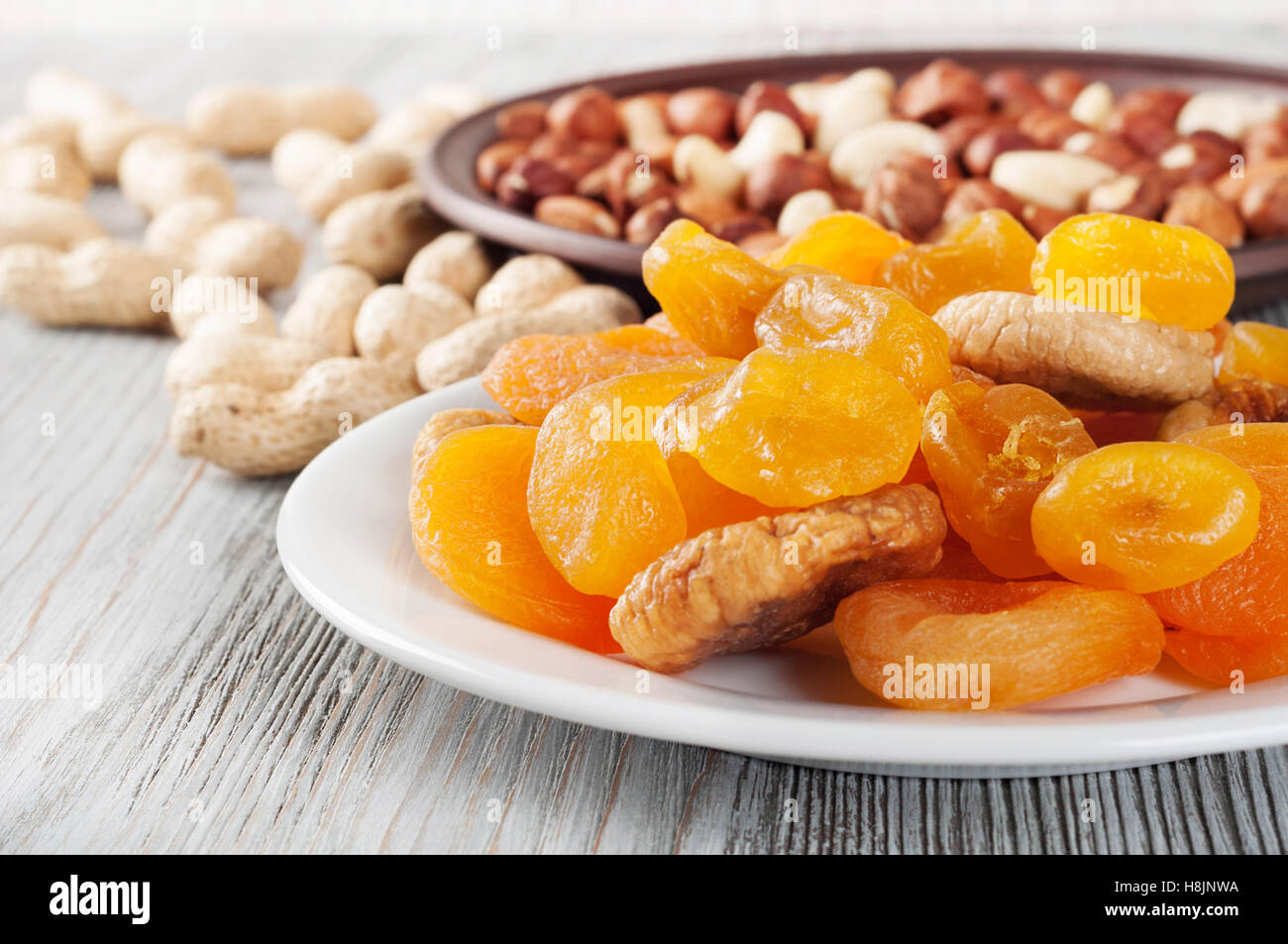 Dried fruits and nuts on a wooden background. Candied fruits, lemon