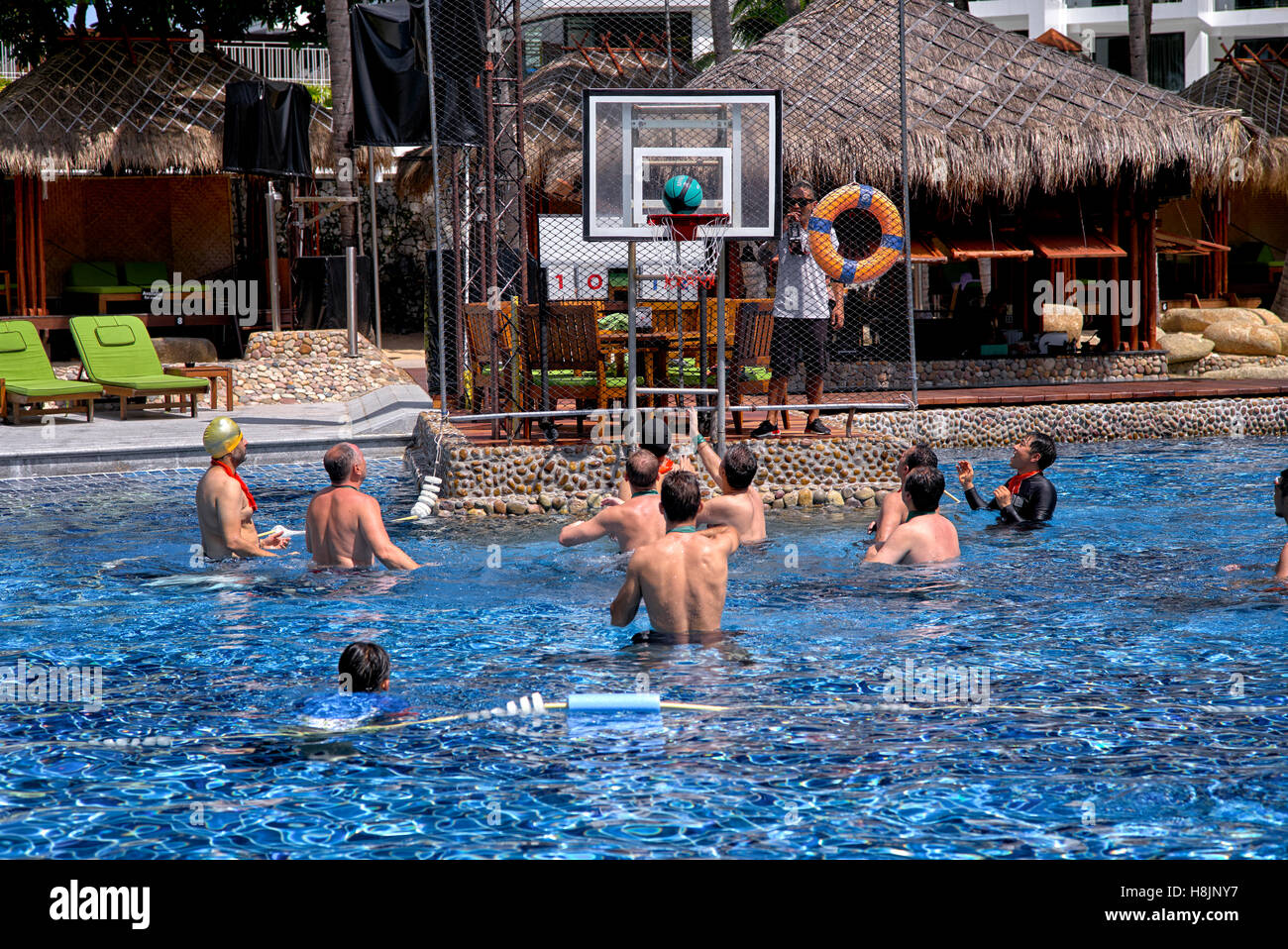 Water polo. Group of male tourists playing water polo at the Hard Rock Hotel, Pattaya Thailand S. E. Asia Stock Photo