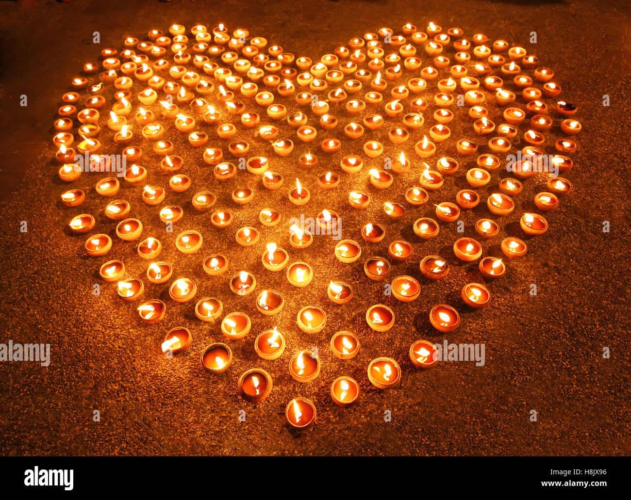 Love heart shape made out of candles and light Stock Photo Alamy