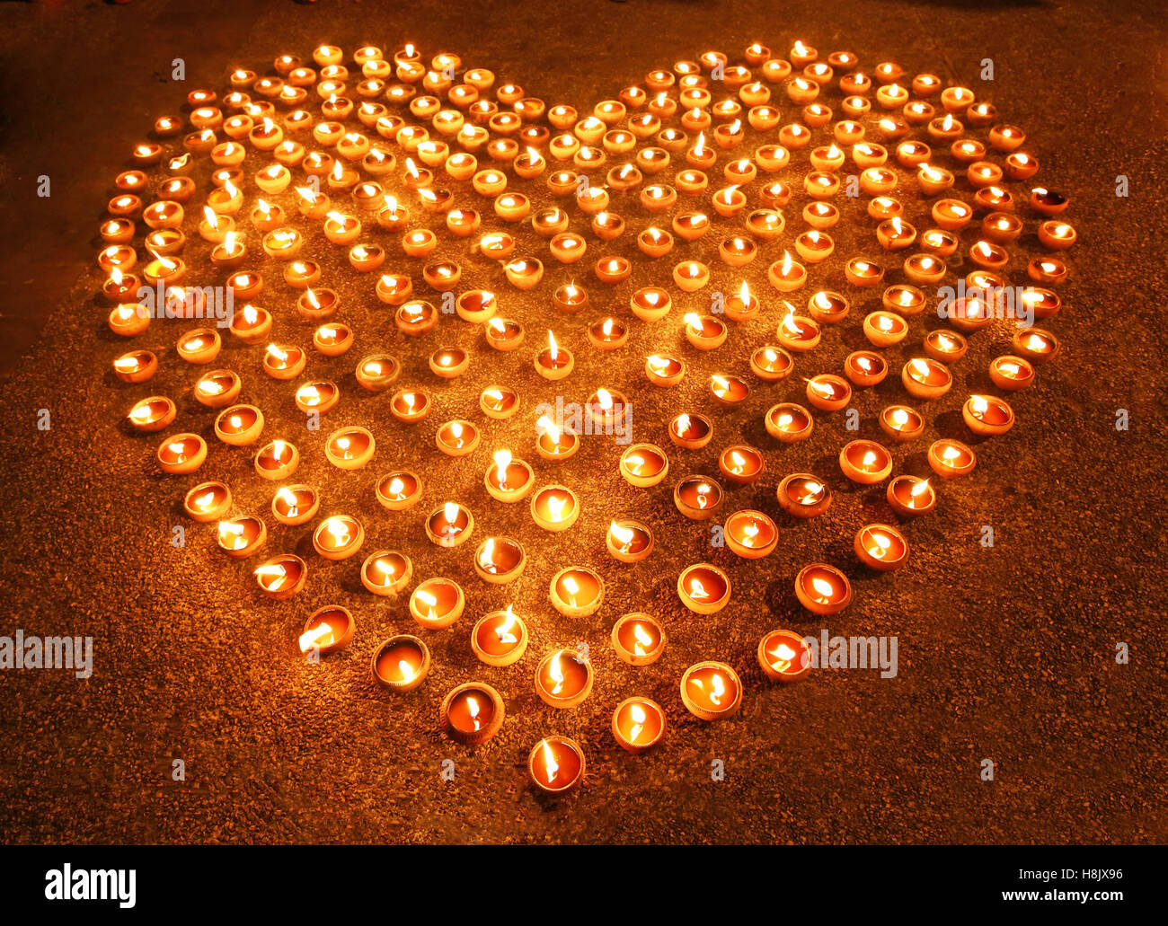 Love heart shape made out of candles and light Stock Photo