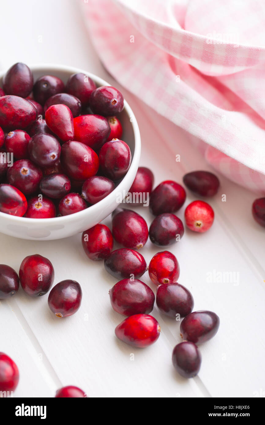 The tasty american cranberries in bowl on white table. Stock Photo