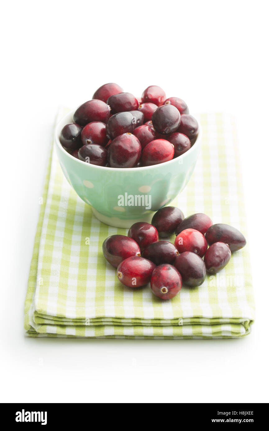 The tasty american cranberries in bowl on checkered napkin. Stock Photo