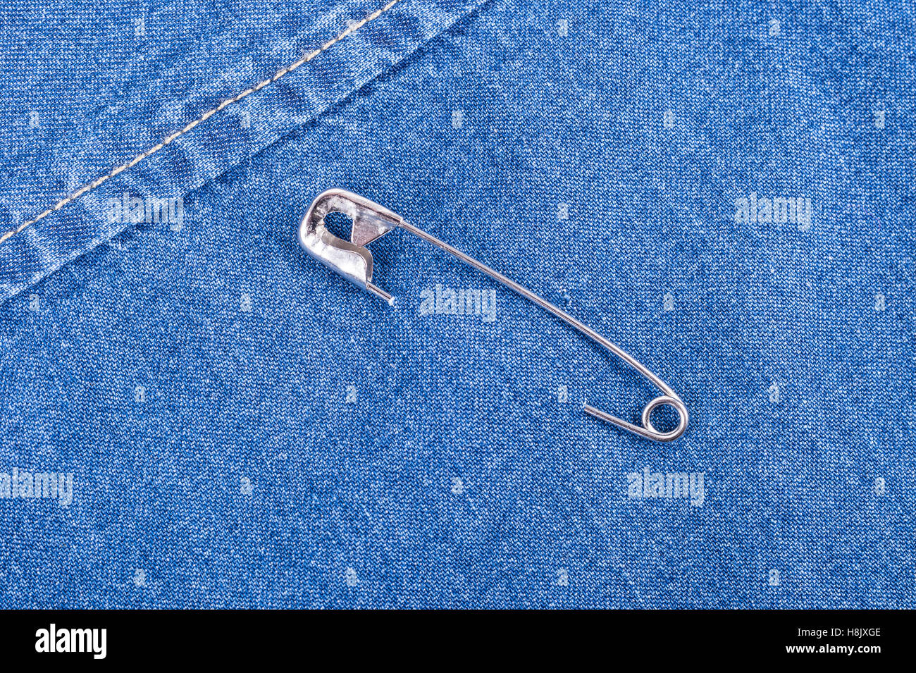 Safety pin on clothes as a symbol of solidarity Stock Photo - Alamy