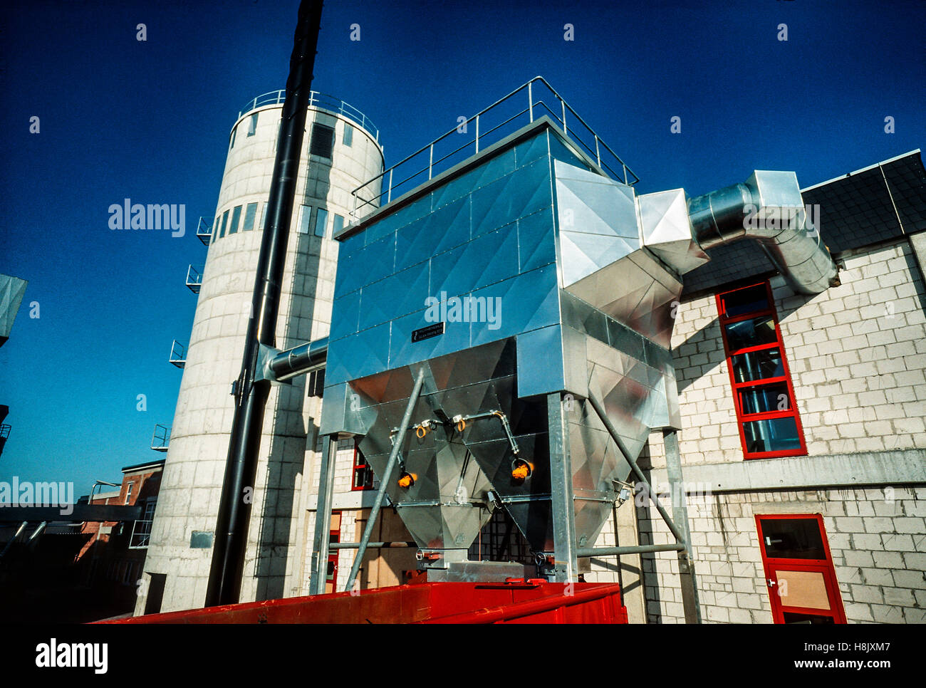 Electric cleaner of an incinerator with chip reservoir and chimney at a kitchen factory in Germany. Stock Photo