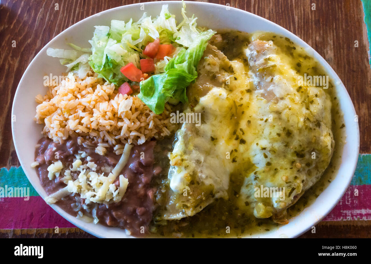 Chicken enchiladas refried beans rice hi-res stock photography and
