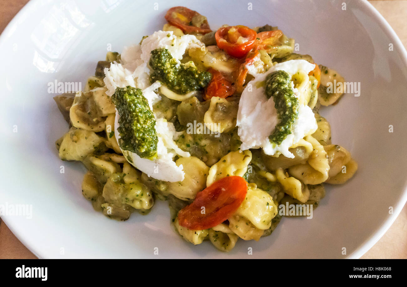 Orecchiette with eggplant, mozzarella, pesto, and cherry tomatoes Stock