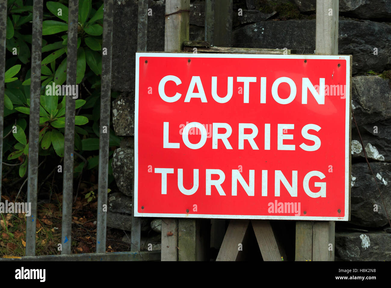 Red and white Caution Lorries Turning sign Stock Photo
