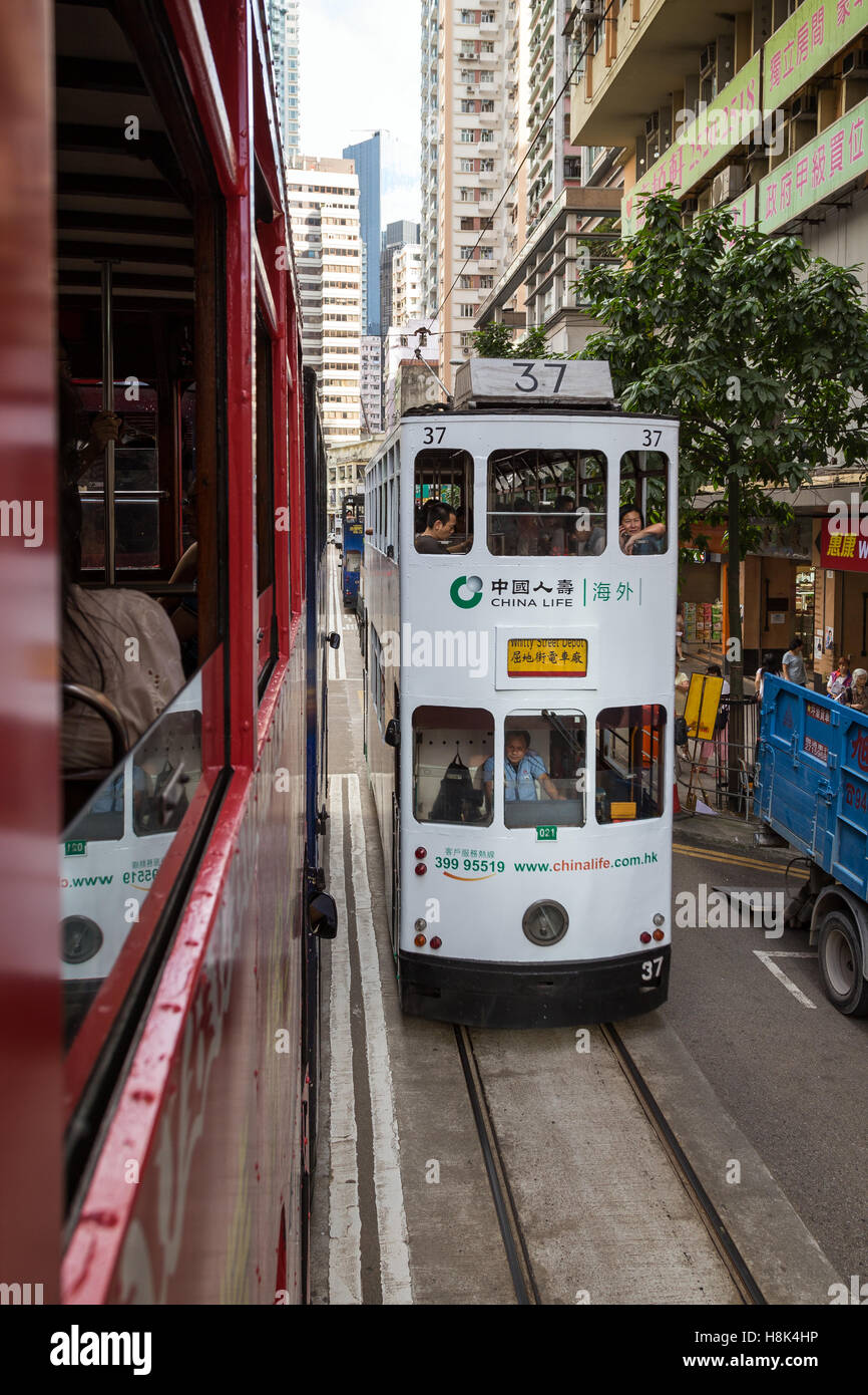 view-of-a-white-tram-and-street-from-the-upper-deck-of-a-double-decker