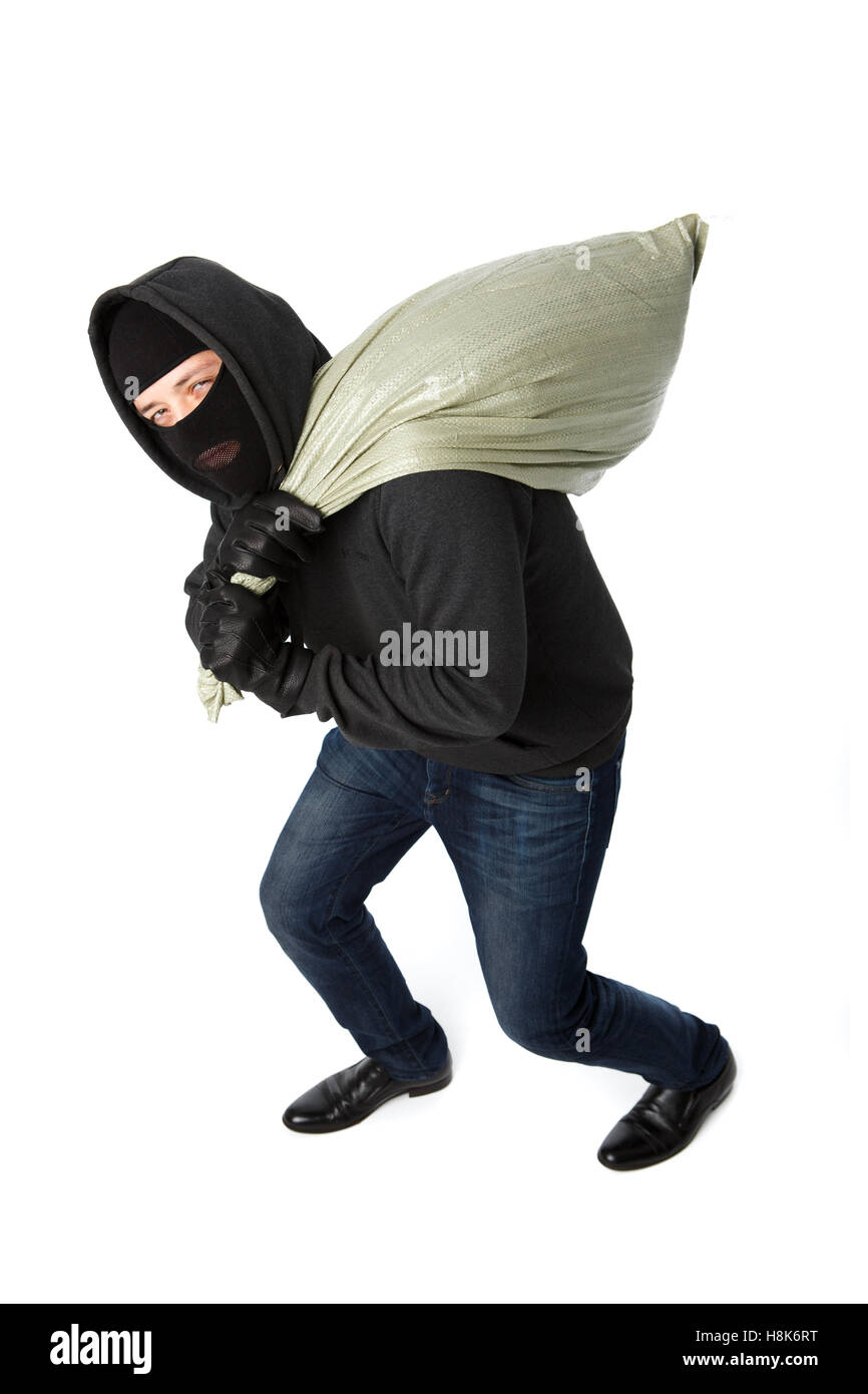 Thief with heavy black bag Stock Photo